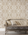 Pure Fern Fantasy removable wallpaper in taupe and cream creating elegant damask pattern behind vintage sofa