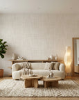 Quiet Cloth serene beige linen texture wallpaper in a warm and inviting living room