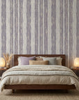 Quiet Dusk textured lavender striped wallpaper adding character to a cozy bedroom