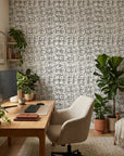 Quiet Herringbone neutral abstract peel and stick wallpaper as a feature wall in a bright home office