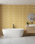 Rolling Fathoms golden painterly leaf wallpaper creating ambiance in a serene bathroom
