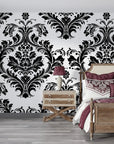 Black and white baroque damask Rosette Haven peel and stick wallpaper in elegant bedroom setting