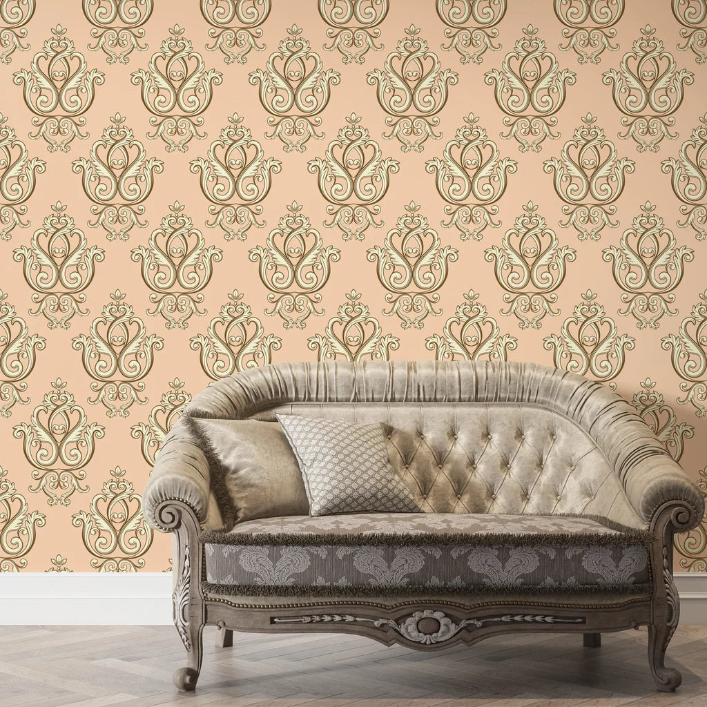 Peach and gold Rosewater Retreat damask wallpaper behind tufted vintage sofa in elegant living room