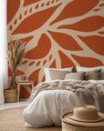 Stylized leaf pattern peel and stick wall covering in earthy terracotta and light beige tones (Rust Echoes collection)
