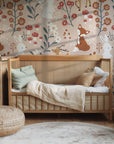 Forest animal wallpaper installed on a bedroom wall with deer fox and rabbit illustrations