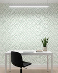 Sage Drop sage green polka dot wallpaper as a feature wall in a bright home office
