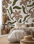 A floral pattern in brown and green, sketched onto textured beige wallpaper, named 'Scrawled Bloom'
