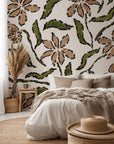 A floral pattern in brown and green, sketched onto textured beige wallpaper, named 'Scrawled Bloom'