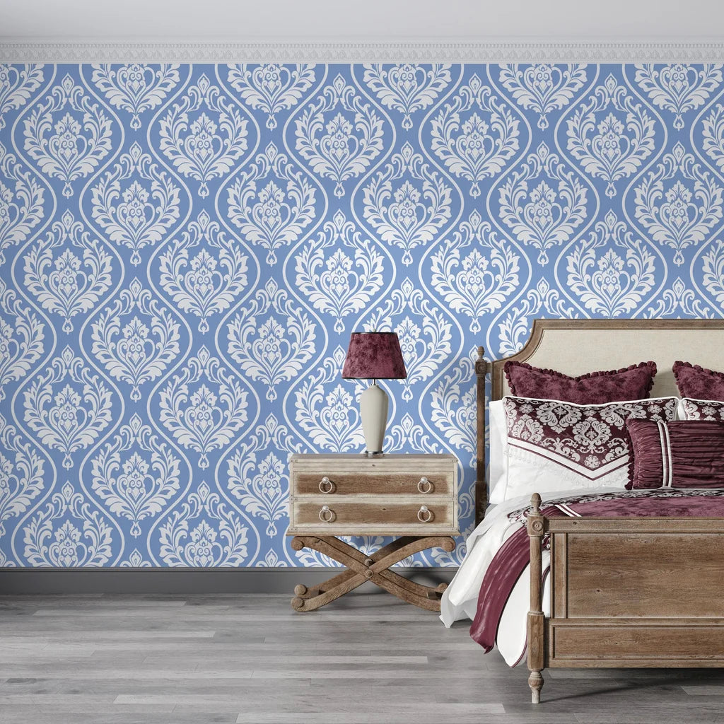 Blue and white Secret Arbor damask wallpaper on bedroom accent wall with ornate floral medallion pattern