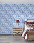 Blue and white Secret Arbor damask wallpaper on bedroom accent wall with ornate floral medallion pattern