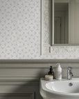 Detailed perspective of the gray patterned wallpaper, showcasing faint texture coupled with variations in shading