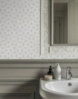 Detailed perspective of the gray patterned wallpaper, showcasing faint texture coupled with variations in shading