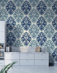 Navy and sage damask Silent Bouquet wallpaper on modern kitchen accent wall with white cabinetry