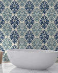 Navy and sage Silent Bouquet damask wallpaper in modern bathroom with freestanding tub