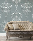 Sage green and white Silent Spring damask wallpaper behind elegant tufted settee in styled living room