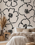 Minimalist black and ivory floral wallpaper with bold hand drawn flower outlines and clustered dotted centers.