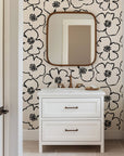 Minimalist black and ivory floral wallpaper with bold hand drawn flower outlines and clustered dotted centers.
