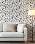 Minimalist black and ivory floral wallpaper with bold hand drawn flower outlines and clustered dotted centers.