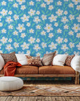 White chalk-sketch daisies printed on a vibrant blue wallpaper