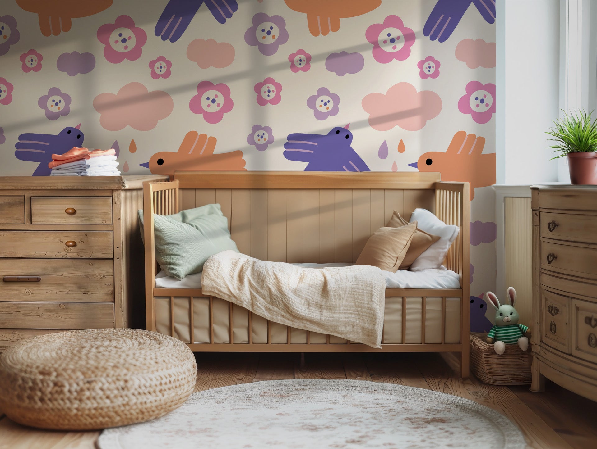 Pastel bird and flower wallpaper installed in a child’s bedroom, adding a whimsical and calming feel with soft clouds and playful illustrations.