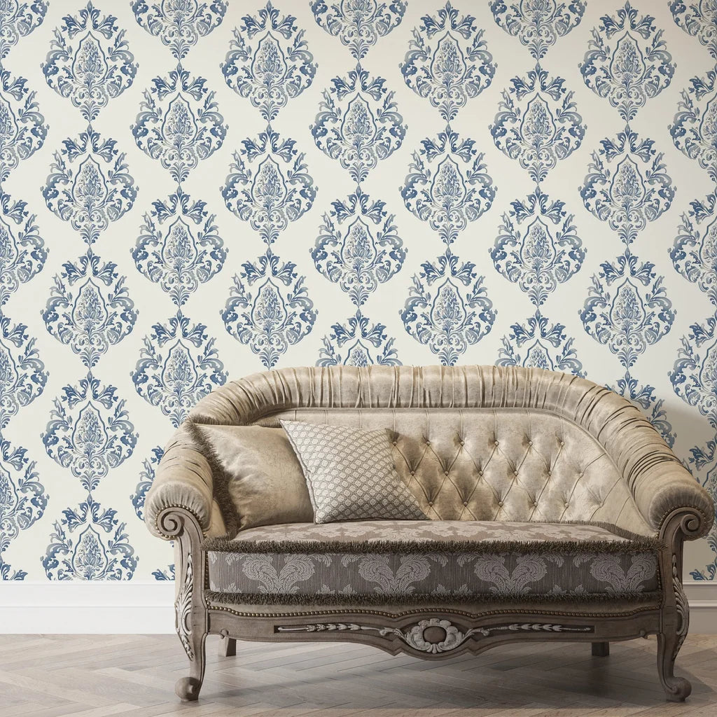 Blue and cream damask Soft Petal Rhapsody wallpaper behind elegant tufted sofa in classic living room