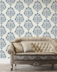 Blue and cream damask Soft Petal Rhapsody wallpaper behind elegant tufted sofa in classic living room