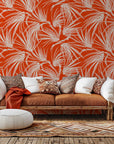 A wall covering known as Solar Fronds, showcasing a white tropical palm leaf motif against a vivid orange backdrop
