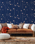Celestial patterned wallpaper in navy blue, decorated with pink starry elements and lines.