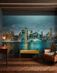 Teal Nocturne city skyline mural wallpaper on living room accent wall with illuminated waterfront view