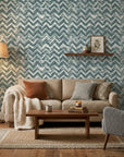 The Depths textured blue chevron wallpaper in a warm and inviting living room