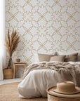 Floral quatrefoil design detailed with thin gold lines against a light backdrop