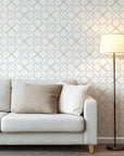 Golden borders outline a repeating botanical quatrefoil pattern, set upon a simple white backdrop