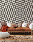 Self-adhesive wallpaper featuring a black and white geometric pattern of triangular stripes, product code Ticking Wings