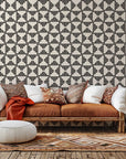 Self-adhesive wallpaper featuring a black and white geometric pattern of triangular stripes, product code Ticking Wings