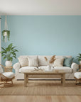 Tidal Hum modern blue wave wallpaper in a warm and inviting living room