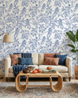 Toucan Toile blue and white tropical bird wallpaper in a warm and inviting living room