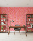 Tropic Flame bold pink and orange tropical wallpaper as a feature wall in a bright home office