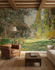 Impressionist garden mural wallpaper featuring turquoise water, blooming trees, and lush foliage in living room setting