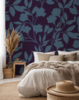 A deep violet wall covering adorned with a winding blue flower silhouette design