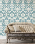 Duck egg blue and cream damask wallpaper with ornate baroque motifs behind tufted vintage sofa