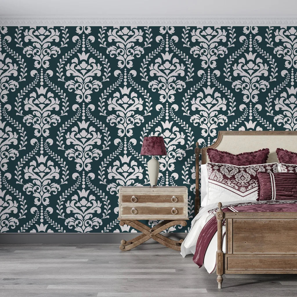 Dark teal and cream Veiled Botany damask wallpaper on bedroom accent wall with vintage furnishings