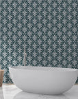 Veiled Botany damask wallpaper in teal and cream behind modern freestanding bathtub
