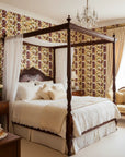 Velvet Orchid romantic burgundy and gold floral wallpaper adding character to a cozy bedroom