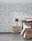 Slate blue and cream Velvet Vine Serenade damask wallpaper on bedroom accent wall with ornate scrollwork pattern