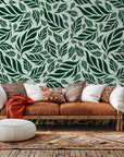 Dark green wallpaper showcasing a thick, botanical pattern of closely packed tropical leaves