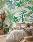 Soft green botanical leaves hand-painted in watercolor on a white self-adhesive wallpaper background.