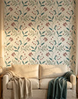 Vermillion Stem teal and red botanical wallpaper in a warm and inviting living room