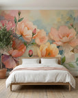 Watercolor floral wallpaper mural with oversized peach and pink blooms on soft watercolor background in bedroom setting