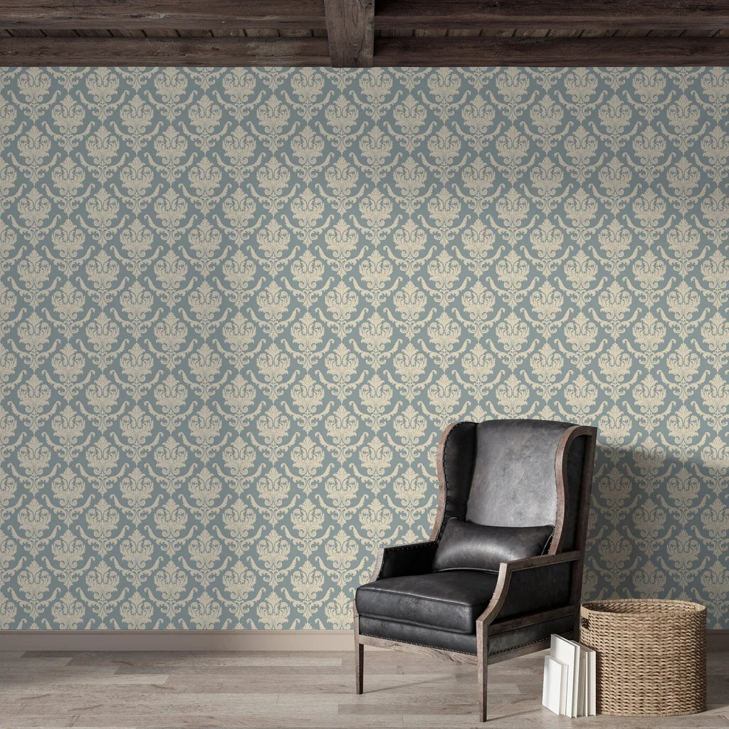 Woodland Blossom Veil damask wallpaper in dusty blue and cream adorning rustic living room with leather chair