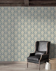 Woodland Blossom Veil damask wallpaper in dusty blue and cream adorning rustic living room with leather chair